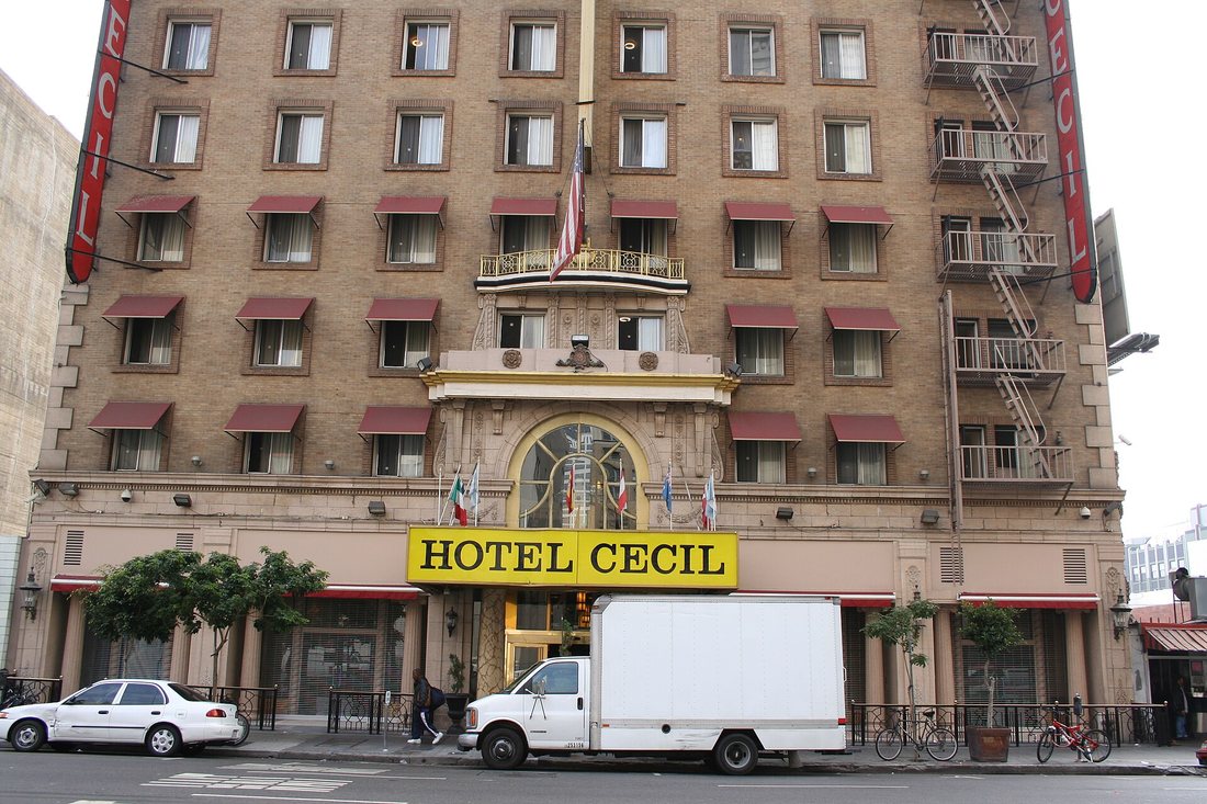 Los Angeles Main Street'te 14 katlı tuğla Cecil Oteli; girişte sarı zemin üzerine siyah harflerle HOTEL CECIL tabelası, cephede yangın merdiveni